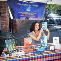 Francesca pointing to her book, Blue Mar, at a signing outside Jan's Paperbacks in Beaverton, Oregon.