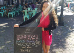 Francesca Varela standing next to a books sign outside.