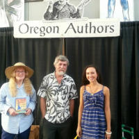 Francesca Varela standing with two fellow writers in front of a sign that says Oregon Authors.